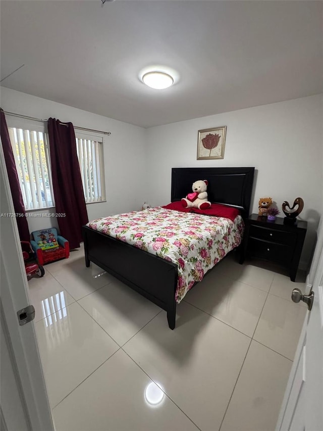 bedroom with light tile patterned floors