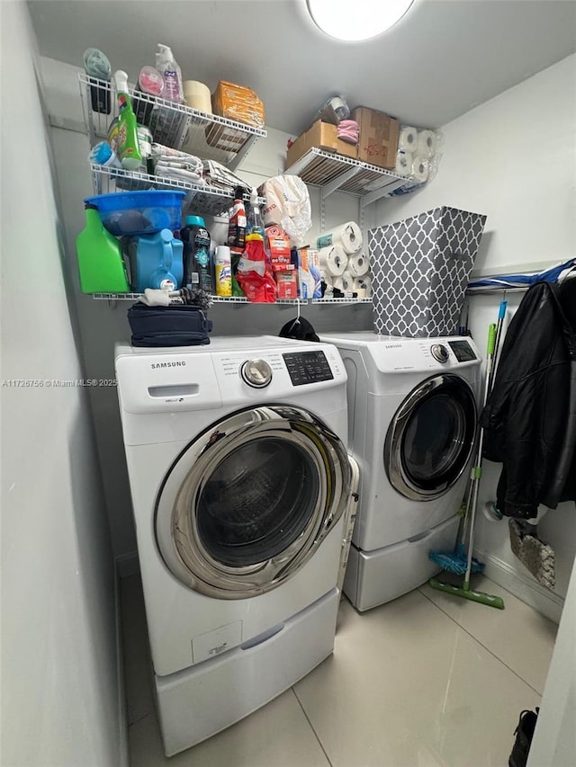 laundry room with tile patterned floors and washer and clothes dryer