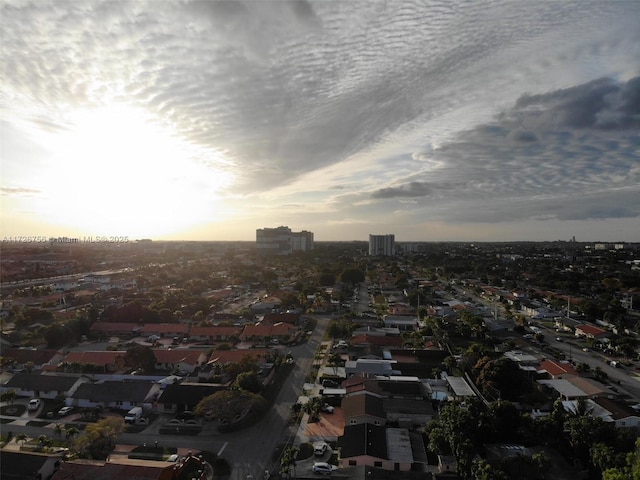 aerial view at dusk featuring a water view