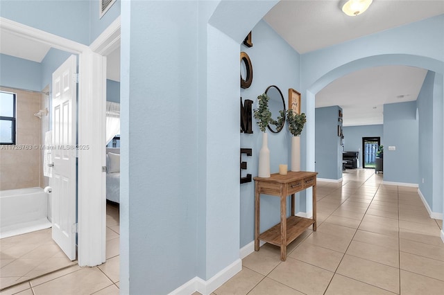 hall with light tile patterned floors