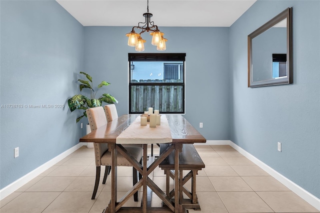 tiled dining space featuring an inviting chandelier