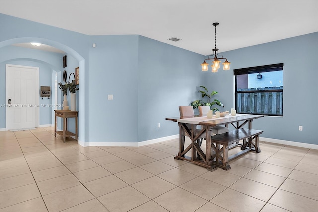 dining room featuring light tile patterned floors and a notable chandelier