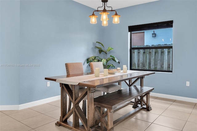 dining area with an inviting chandelier and light tile patterned flooring