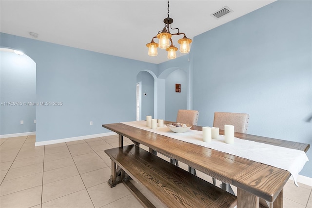 dining space featuring an inviting chandelier and light tile patterned floors