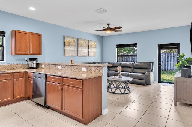 kitchen featuring ceiling fan, light tile patterned floors, kitchen peninsula, and light stone countertops