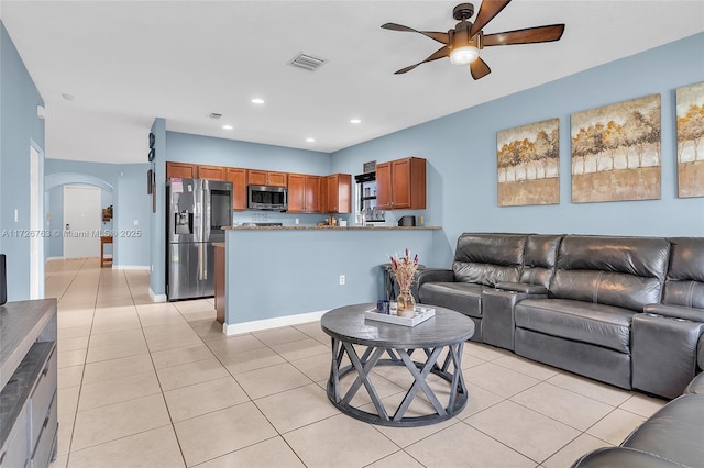 tiled living room with ceiling fan