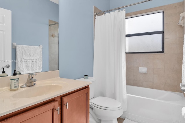 full bathroom featuring toilet, shower / bath combo, and vanity