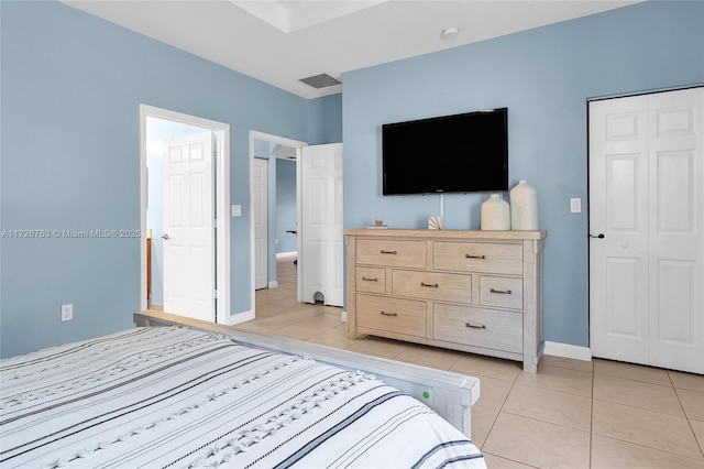 bedroom with a closet and light tile patterned flooring