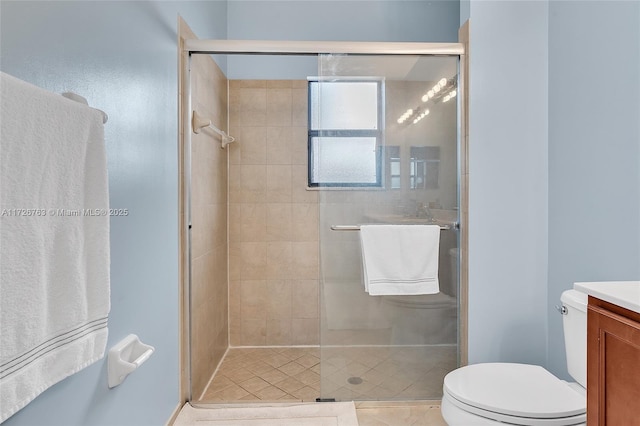 bathroom with vanity, toilet, tile patterned flooring, and walk in shower