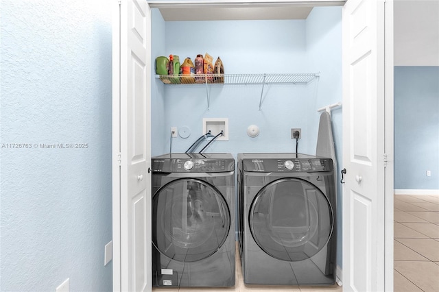 laundry area featuring tile patterned flooring and washer and dryer