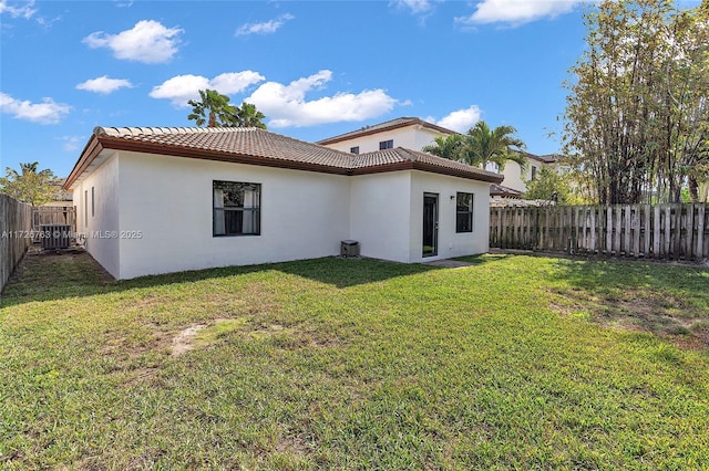 rear view of property with a yard