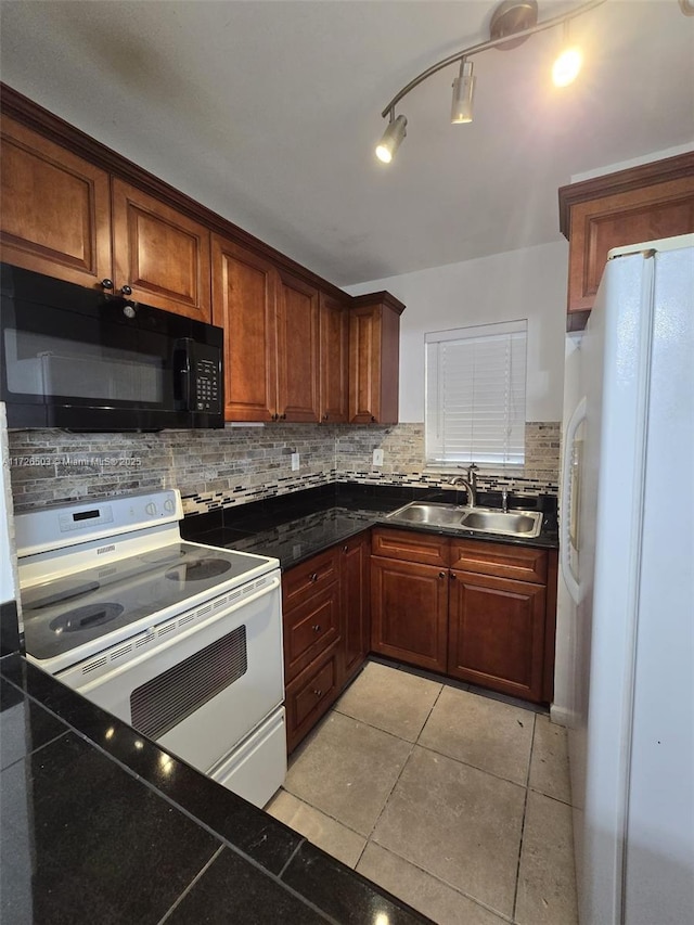 kitchen with light tile patterned floors, sink, white appliances, and backsplash