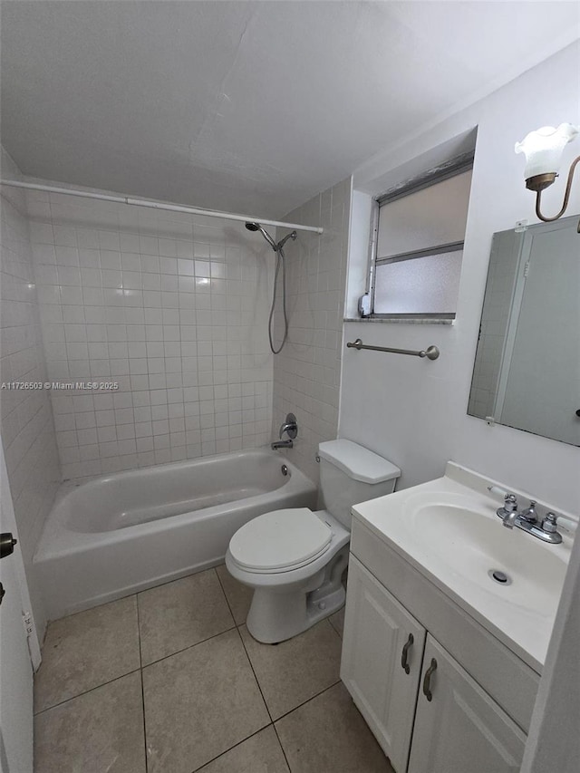 full bathroom featuring tiled shower / bath combo, vanity, toilet, and tile patterned flooring