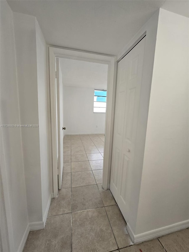 hall featuring light tile patterned flooring