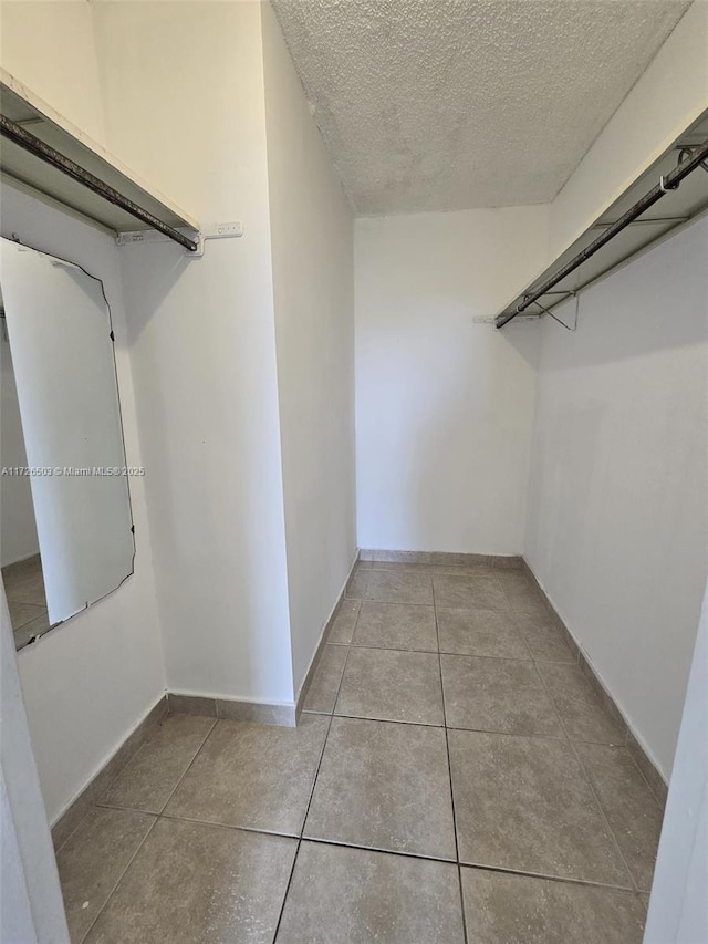 spacious closet featuring light tile patterned flooring