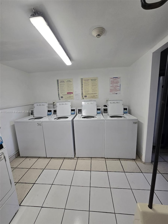 laundry area featuring light tile patterned floors and washer and dryer