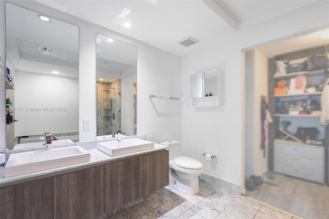 full bath featuring visible vents, toilet, and a sink