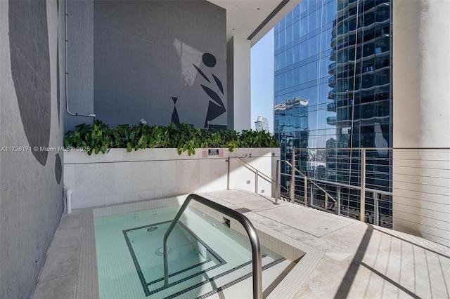 balcony featuring a view of city and a hot tub