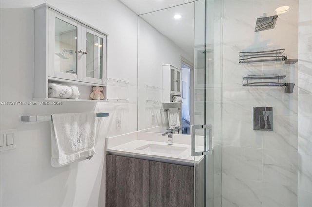 bathroom featuring an enclosed shower and vanity