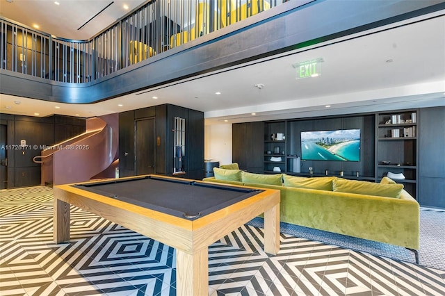 game room featuring a towering ceiling, billiards, recessed lighting, and built in features