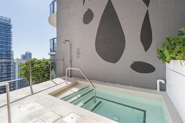 view of pool with a view of city