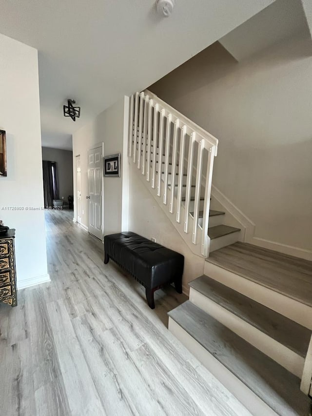 stairway with hardwood / wood-style floors