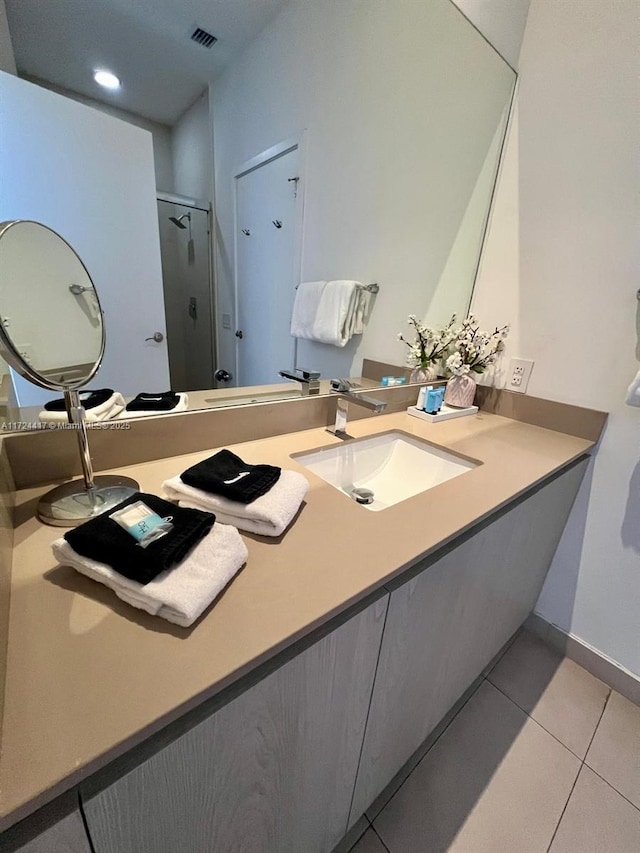 bathroom with tile patterned floors and vanity