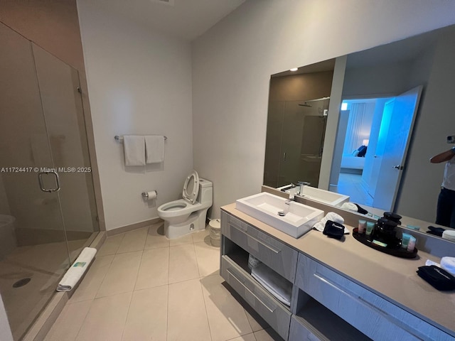 bathroom featuring toilet, an enclosed shower, tile patterned flooring, and vanity