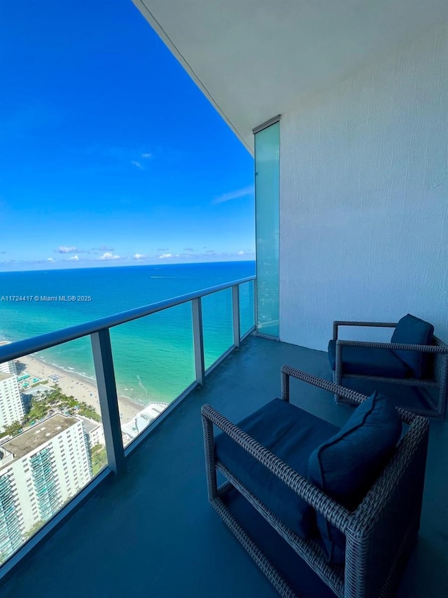 balcony with a beach view and a water view