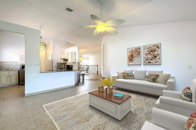 living room with ceiling fan and lofted ceiling