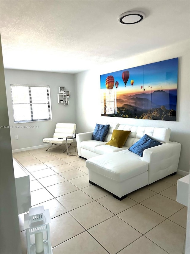 living room featuring light tile patterned floors and a textured ceiling