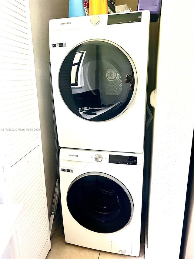 laundry area featuring stacked washing maching and dryer