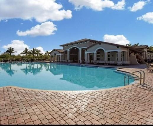 view of swimming pool with a patio