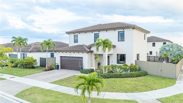 mediterranean / spanish-style house featuring a front lawn and a garage