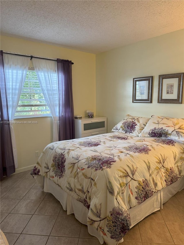 tiled bedroom featuring a textured ceiling