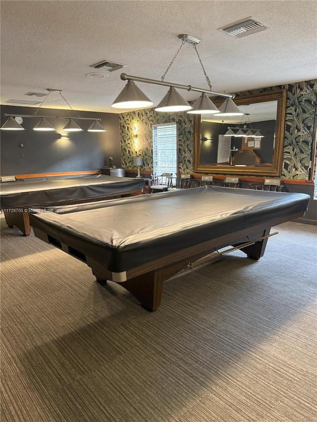 game room with a textured ceiling, pool table, and carpet floors