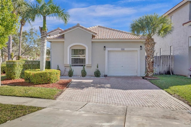 mediterranean / spanish-style home with a garage and a front lawn