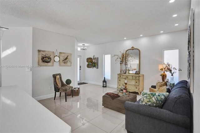 living room with light tile patterned floors and a textured ceiling