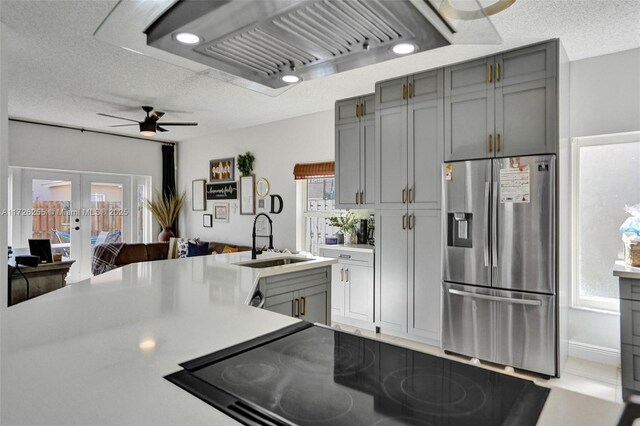 kitchen featuring sink, plenty of natural light, stainless steel fridge with ice dispenser, and french doors