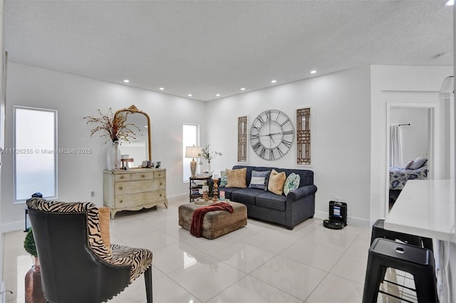 tiled living room featuring a textured ceiling