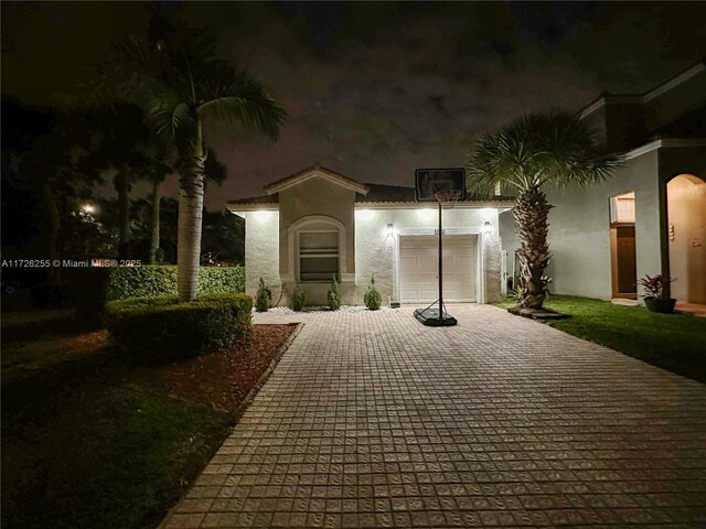 view of front of home with a front yard and a garage