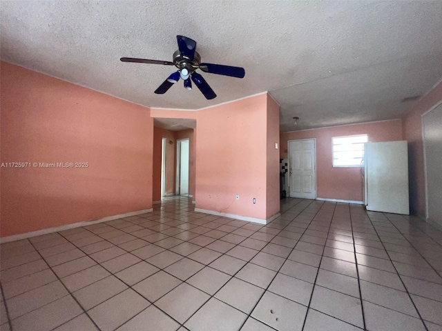 tiled empty room with a textured ceiling and ceiling fan