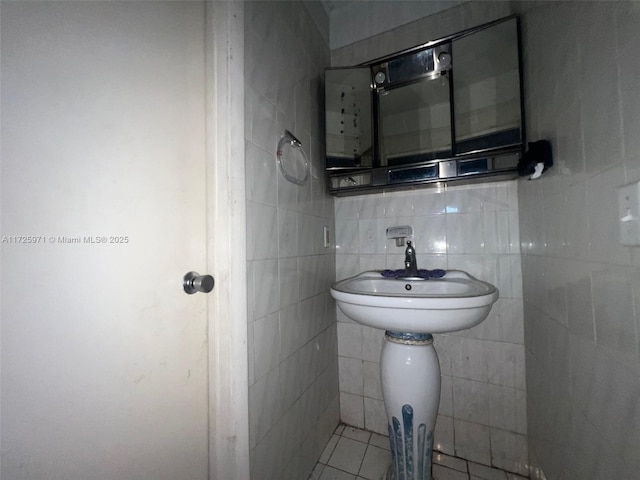 bathroom with sink, tile patterned floors, and decorative backsplash