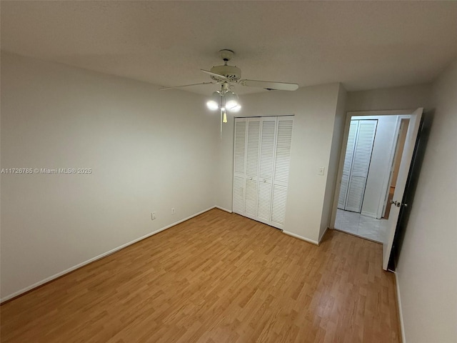 unfurnished bedroom featuring a closet, ceiling fan, and light hardwood / wood-style floors