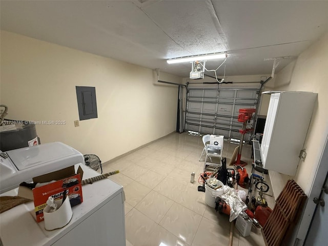 garage featuring electric panel, independent washer and dryer, and a garage door opener