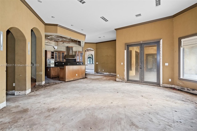 unfurnished living room featuring crown molding