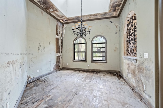 unfurnished dining area with a high ceiling and an inviting chandelier