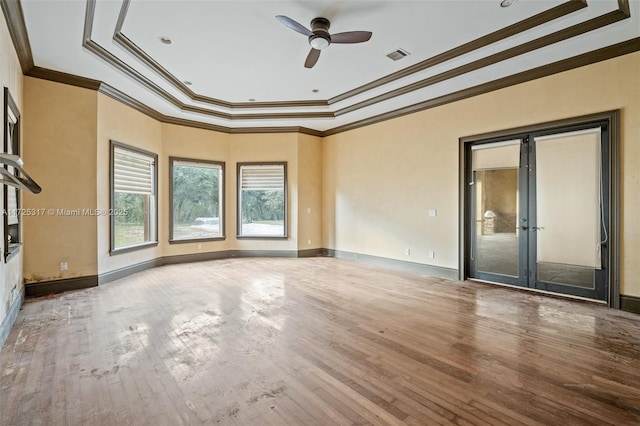 empty room featuring ceiling fan, french doors, ornamental molding, and hardwood / wood-style flooring