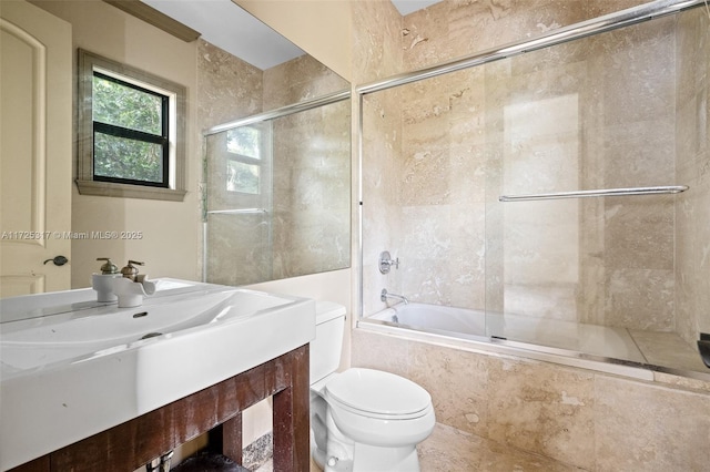 full bathroom with vanity, combined bath / shower with glass door, and toilet