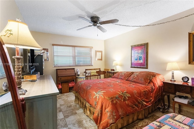 bedroom featuring a textured ceiling and ceiling fan